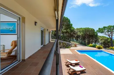 a view from the balcony of a house with a swimming pool at Mediterranean villa with pool near barcelona in Cabrera de Mar