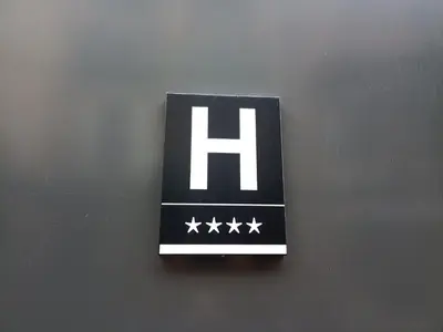 a sign with the letter h on a wall at Hotel Orangine in Hospitalet de Llobregat
