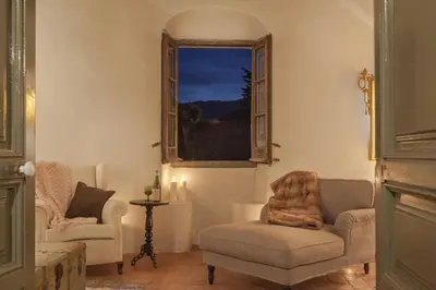 a living room with two chairs and a window at Masia Victoria in Sant Pere de Ribes