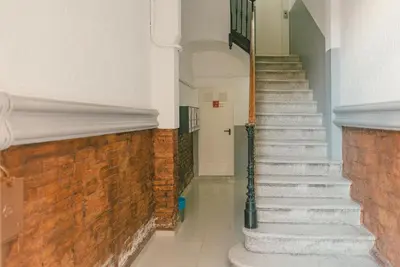 a hallway with stairs and a brick wall at Brummell Apartments Montjuic in Barcelona