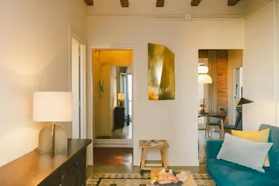 a living room with a blue couch and a table at Brummell Apartments Montjuic in Barcelona