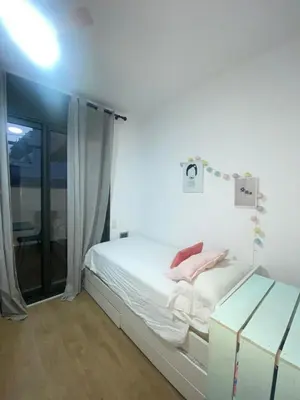 a white bedroom with a bed and a window at Casa grande y céntrica con piscina en zona peatonal in Montgat