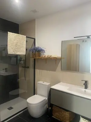 a bathroom with a toilet and a sink and a shower at Casa grande y céntrica con piscina en zona peatonal in Montgat