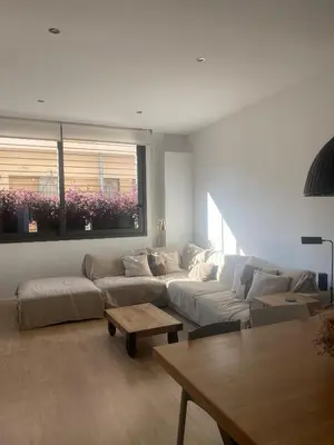 a living room with a couch and a table at Casa grande y céntrica con piscina en zona peatonal in Montgat
