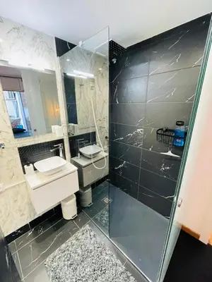 a bathroom with two sinks and a glass shower at Stunning 2 bedroom Apartment with great design Sitges centre beach in Sitges