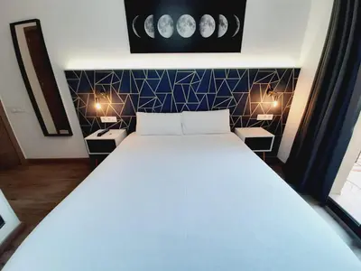 a bedroom with a large bed with two night stands at Hostal Laia by gaiarooms in Barcelona