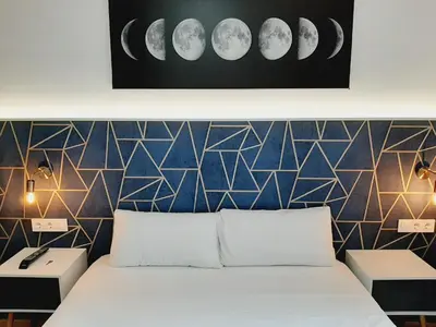 a bedroom with a bed and a wall with phases at Hostal Laia by gaiarooms in Barcelona