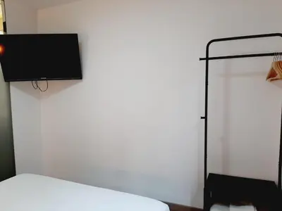 a bedroom with a bed and a tv on the wall at Hostal Laia by gaiarooms in Barcelona