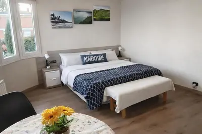 a bedroom with a bed and a table and two windows at Catalunya Casas Stunning Villa with private pool 33 km to Barcelona in Senmanat