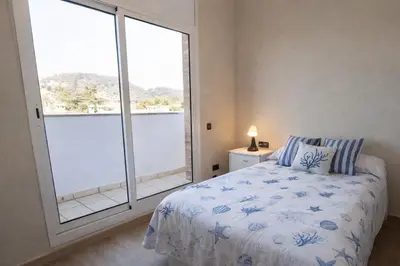 a bedroom with a bed and a large window at Catalunya Casas Stunning Villa with private pool 33 km to Barcelona in Senmanat