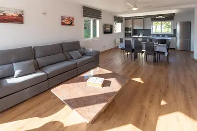 a living room with a couch and a dining room at Catalunya Casas Stunning Villa with private pool 33 km to Barcelona in Senmanat