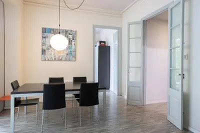 a dining room with a table and chairs at ApartEasy - Casanova Elegance in Barcelona
