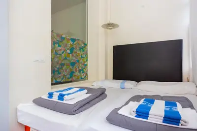 a bed with two pillows on top of it at ApartEasy - Casanova Elegance in Barcelona