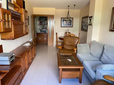 a living room with a couch and a table at Sitges Living Apartment in Sitges