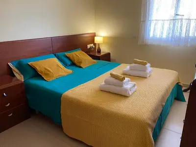 a bedroom with two beds with towels on them at Sitges Living Apartment in Sitges
