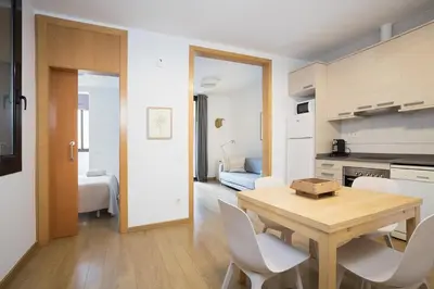 a kitchen and dining room with a table and chairs at Stay U-nique Apartments Villarroel in Barcelona
