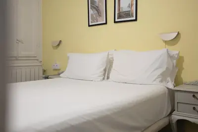 a bed with white sheets and pillows in a bedroom at Stay U-nique Apartments Estación del Norte in Barcelona