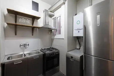 a kitchen with a stainless steel refrigerator and a sink at Stay U-nique Apartments Estación del Norte in Barcelona