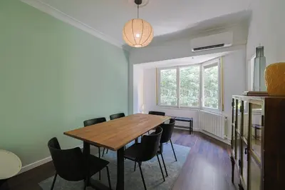 a dining room with a wooden table and chairs at Stay U-nique Apartments Estación del Norte in Barcelona