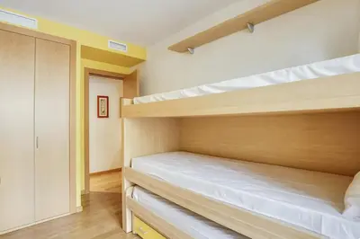 a bedroom with two bunk beds and a hallway at Stay U-nique Apartments Diagonal Mar in Barcelona
