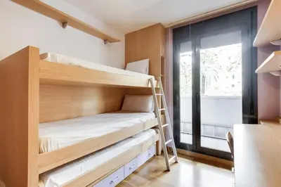 a room with bunk beds and a window at Stay U-nique Apartments Diagonal Mar in Barcelona