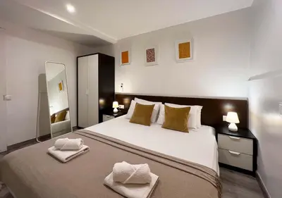 a bedroom with a large bed with two towels on it at Stay U-nique Apartments Tordera in Barcelona
