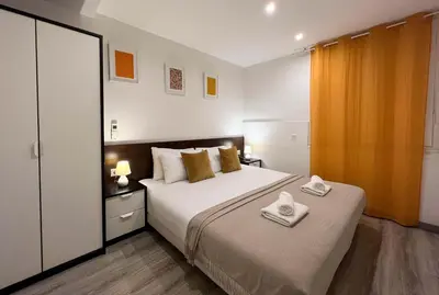 a bedroom with a bed with two towels on it at Stay U-nique Apartments Tordera in Barcelona