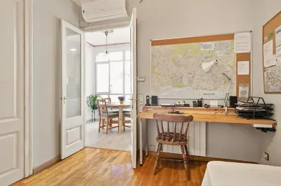 a home office with a desk and a map on the wall at Stay U-nique Apartments Hospital Clinic in Barcelona