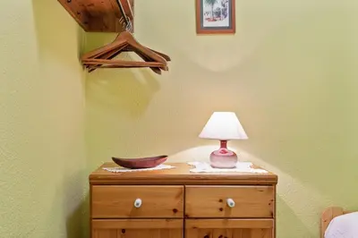 a lamp on top of a wooden dresser in a bedroom at Stay U-nique Apartments Hospital Clinic in Barcelona