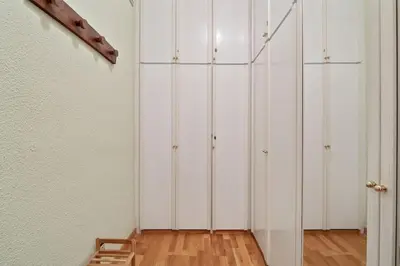a room with white cabinets and a wooden floor at Stay U-nique Apartments Hospital Clinic in Barcelona