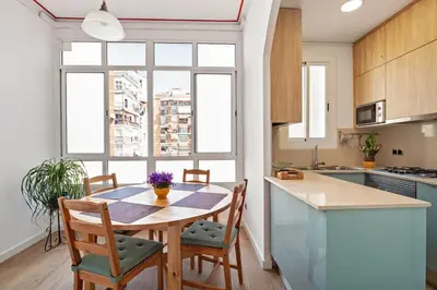 a kitchen with a table and chairs and a window at Stay U-nique Apartments Hospital Clinic in Barcelona