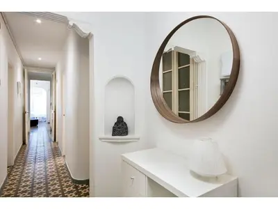 a white bathroom with a mirror and a hallway at Stay U-nique Apartments Napols I in Barcelona