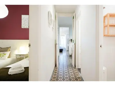 a hotel room with a bed and a hallway with a room at Stay U-nique Apartments Napols I in Barcelona