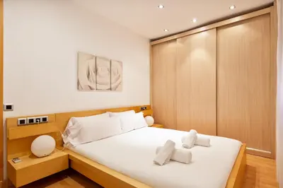 a bedroom with a bed with two towels on it at Stay U-nique Apartments Terrassa in Barcelona