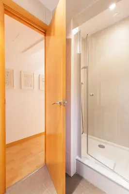 a bathroom with a shower and a glass door at Stay U-nique Apartments Terrassa in Barcelona
