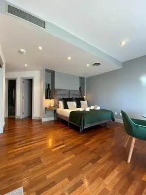 a bedroom with a bed and a wooden floor at Stay U-nique Apartments Passeig de Gracia II in Barcelona