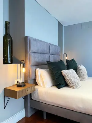a bedroom with a bed with a headboard and a table at Stay U-nique Apartments Passeig de Gracia II in Barcelona