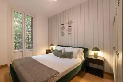 a bedroom with a bed and two lamps and a window at Stay U-nique Apartments Sant Antoni in Barcelona
