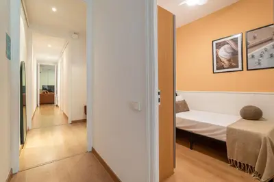 a small room with a bed and a hallway at Stay U-nique Apartments Sant Antoni in Barcelona