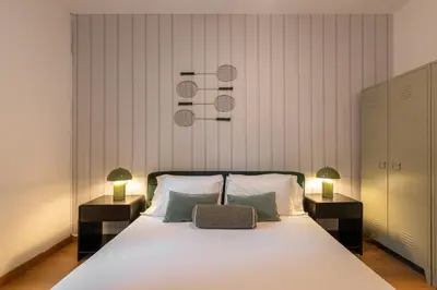 a bedroom with a large white bed with two lamps at Stay U-nique Apartments Sant Antoni in Barcelona