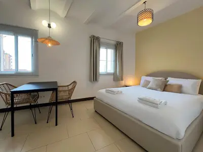 a bedroom with a bed and a table and chairs at Stay U-nique Apartments Pasteur in Barcelona