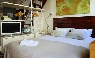a bedroom with a bed with a tv on a shelf at Stay U-nique Apartments Monec in Barcelona