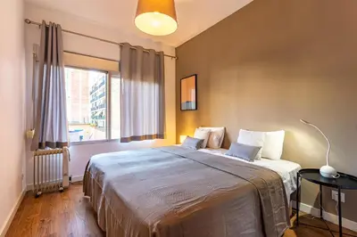 a bedroom with a large bed and a window at Stay U-nique Apartments Parlament in Barcelona