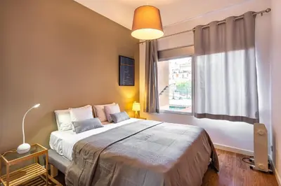 a bedroom with a large bed and a window at Stay U-nique Apartments Parlament in Barcelona