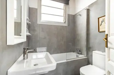 a bathroom with a sink and a toilet and a window at Stay U-nique Apartments Gran Via in Barcelona