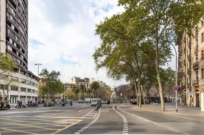 an empty city street with motorcycles on the road at Stay U-nique Apartments Gran Via in Barcelona