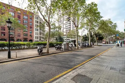 a street with motorcycles parked on the side of the road at Stay U-nique Apartments Gran Via in Barcelona