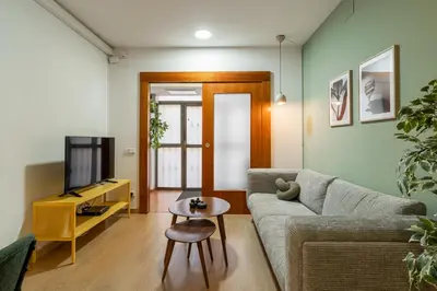 a living room with a couch and a tv at Stay U-nique Apartments Passatge de Font in Barcelona