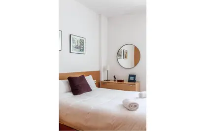 a bedroom with a bed and a mirror at Stay U-nique Apartments Industria in Barcelona