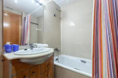 a bathroom with a sink and a bath tub at Stay U-nique Apartments Industria in Barcelona